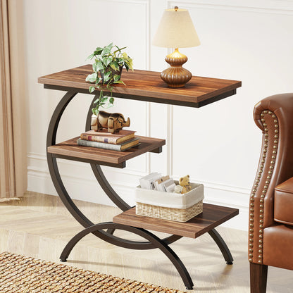C shaped end table in chocolate finish styled with a table lamp, decorative figurine and a storage basket