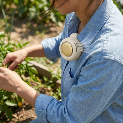 Bladeless clip-on fan clipped onto a shirt outdoors