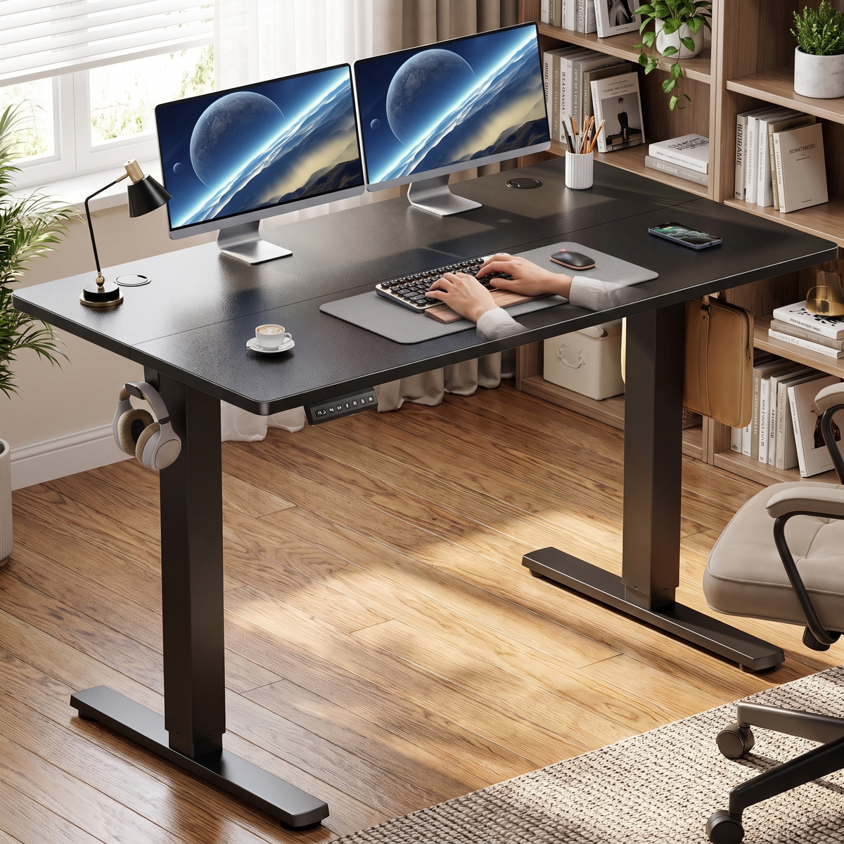 Electric standing desk in black, in use in a home office