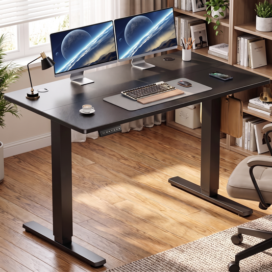 Electric Standing Desk in Black, raised to standing height in a home office