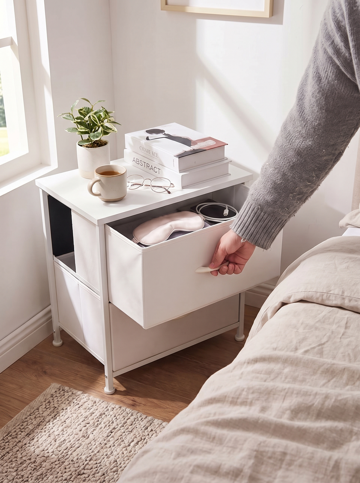 Slim white 2 drawer nightstand fitting neatly beside a bed in a small bedroom