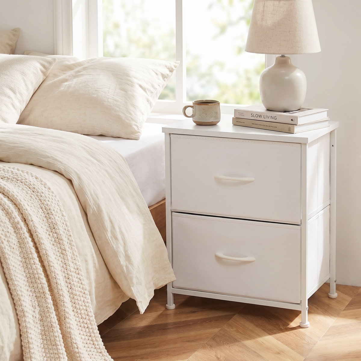White 2-drawer fabric nightstand styled beside a bed